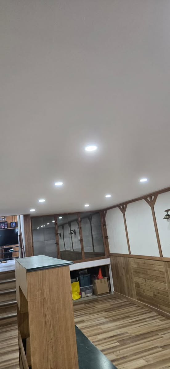 Completed basement open-concept space with full pot light layout