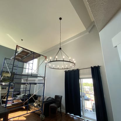 Ring chandelier installation in vaulted living room